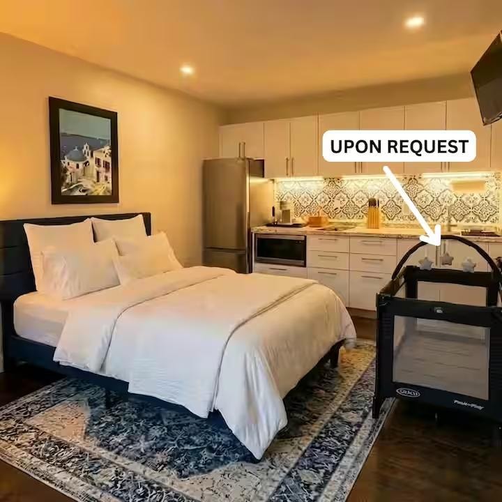 Nightstand with lamp, charging hub and Santorini coffee table books on the bed